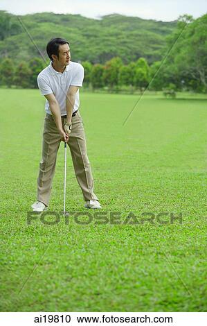 Man preparing to drive golf ball View Large Photo Image Stock Image - Man preparing to drive golf ball. Fotosearch