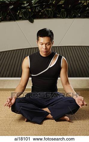 Man sitting in yoga position View Large Photo Image Stock Image - Man sitting in yoga position. Fotosearch