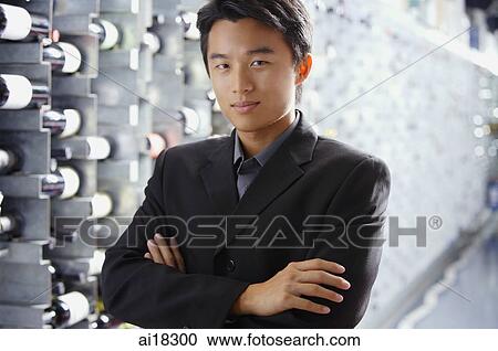 Man standing in wine cellar, arms crossed View Large Photo Image Stock Image - Man standing in wine cellar, arms crossed. Fotosearch