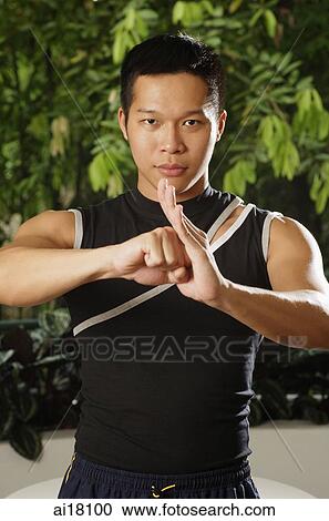 Man standing, looking at camera, with closed fist resting in palm View Large Photo Image Stock Image - Man standing, looking at camera, with closed fist resting in palm. Fotosearch