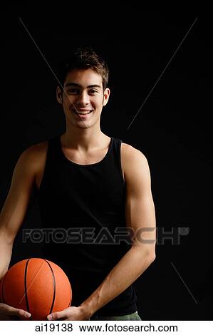 Man standing with basketball, smiling at camera View Large Photo Image Stock Photo - Man standing with basketball, smiling at camera. Fotosearch
