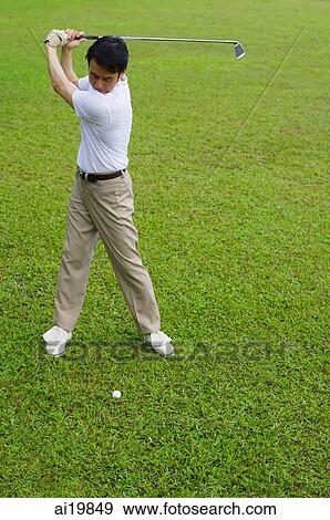 Man swinging golf club View Large Photo Image Stock Photo - Man swinging golf club. Fotosearch