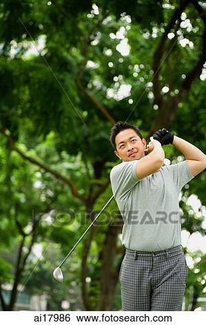 Man swinging golf club View Large Photo Image Stock Photograph - Man swinging golf club. Fotosearch