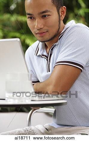 Man using laptop View Large Photo Image Stock Image - Man using laptop. Fotosearch