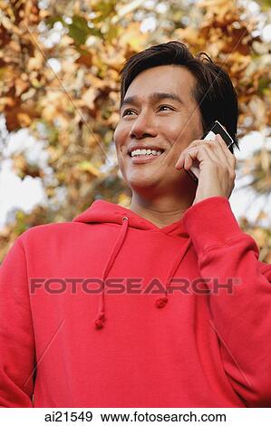 Man using mobile phone, looking away View Large Photo Image Stock Photo - Man using mobile phone, looking away. Fotosearch