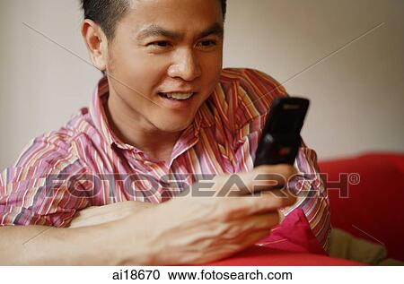 Man using mobile phone, smiling View Large Photo Image Stock Image - Man using mobile phone, smiling. Fotosearch