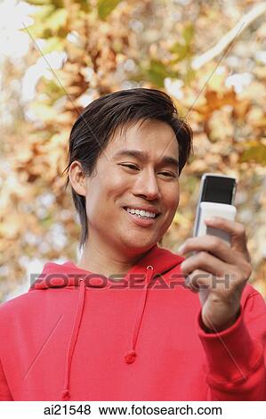 Man using mobile phone View Large Photo Image Stock Photo - Man using mobile phone. Fotosearch