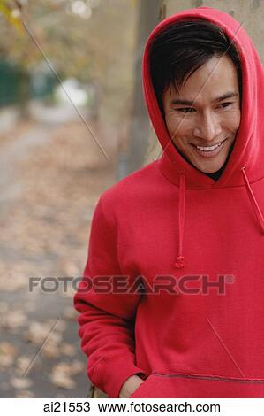 Man wearing red hooded shirt, looking away View Large Photo Image Stock Image - Man wearing red hooded shirt, looking away. Fotosearch