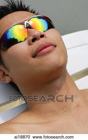 Man wearing sunglasses, head shot View Large Photo Image Stock Image - Man wearing sunglasses, head shot. Fotosearch
