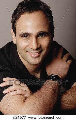 Man with arms crossed, smiling at camera View Large Photo Image Stock Photo - Man with arms crossed, smiling at camera. Fotosearch
