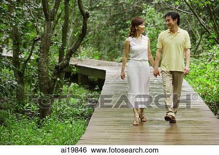 Mature couple walking on path in park, holding hands View Large Photo Image Stock Photograph - Mature couple walking on path in park, holding hands. Fotosearch