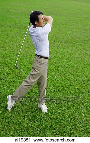 Stock Image - Mature man playing golf. Fotosearch