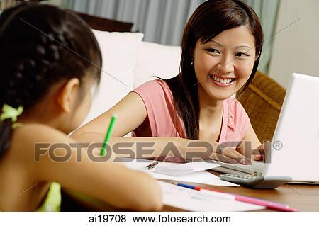 Mother and daughter at home, mother with laptop, daughter drawing on paper View Large Photo Image Stock Photo - Mother and daughter at home, mother with laptop, daughter drawing on paper. Fotosearch