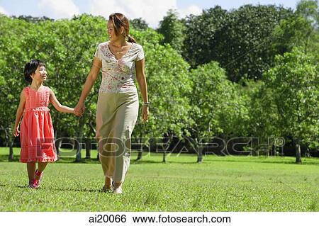 Mother and daughter, holding hands, walking in park View Large Photo Image Stock Photograph - Mother and daughter, holding hands, walking in park. Fotosearch