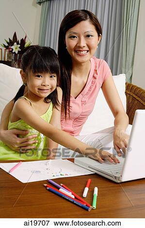 Mother and daughter with laptop, looking at camera View Large Photo Image Stock Photo - Mother and daughter with laptop, looking at camera. Fotosearch