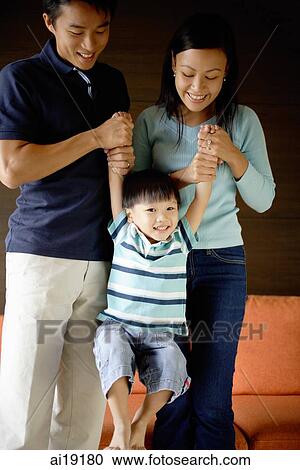 Mother and father holding arms of young boy View Large Photo Image Stock Image - Mother and father holding arms of young boy. Fotosearch