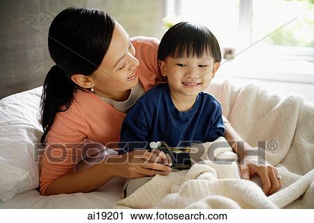 Mother and son in bedroom View Large Photo Image Stock Image - Mother and son in bedroom. Fotosearch
