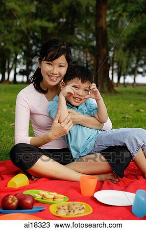 Mother and son on picnic blanket, smiling at camera View Large Photo Image Stock Image - Mother and son on picnic blanket, smiling at camera. Fotosearch
