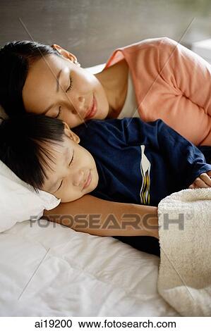 Mother and son sleeping on bed View Large Photo Image Stock Image - Mother and son sleeping on bed. Fotosearch