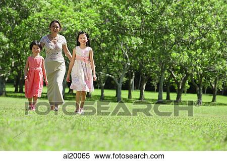 Mother and two daughters walking across field View Large Photo Image Stock Photography - Mother and two daughters walking across field. Fotosearch