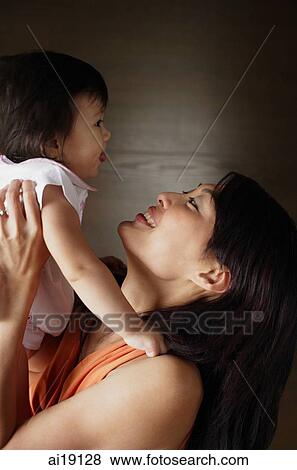 Stock Photo - Mother bonding with young daughter. Fotosearch