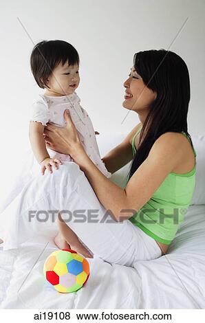 Mother carrying young daughter, portrait View Large Photo Image Stock Photo - Mother carrying young daughter, portrait. Fotosearch