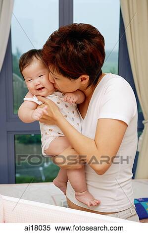 Mother kissing baby girl View Large Photo Image Stock Photography - Mother kissing baby girl. Fotosearch