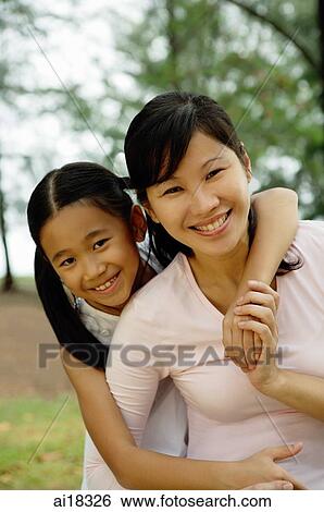 Mother with daughter, smiling at camera View Large Photo Image Stock Photograph - Mother with daughter, smiling at camera. Fotosearch