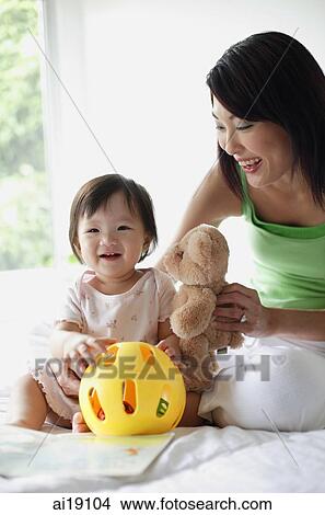 Mother with young daughter, smiling View Large Photo Image Picture - Mother with young daughter, smiling. Fotosearch