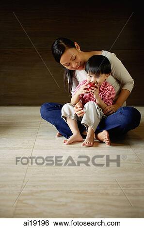 Mother with young son sitting on floor, boy drinking View Large Photo Image Stock Photograph - Mother with young son sitting on floor, boy drinking. Fotosearch