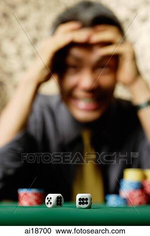 Two dice in foreground, excited man in background, hand on head View Large Photo Image Stock Image - Two dice in foreground, excited man in background, hand on head. Fotosearch