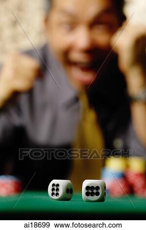 Two dice in foreground, excited man in background View Large Photo Image Stock Photo - Two dice in foreground, excited man in background. Fotosearch
