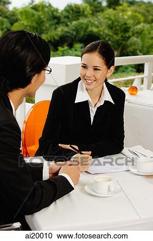 Two executives in restaurant, having a discussion View Large Photo Image Stock Image - Two executives in restaurant, having a discussion. Fotosearch