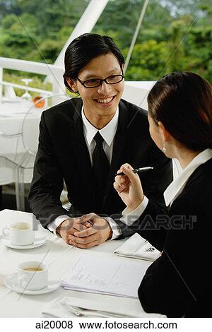 Two executives in restaurant, having a discussion View Large Photo Image Stock Photo - Two executives in restaurant, having a discussion. Fotosearch
