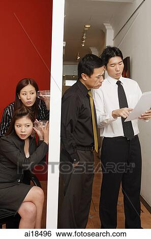 Two female executives eavesdropping on male executives View Large Photo Image Stock Photograph - Two female executives eavesdropping on male executives. Fotosearch