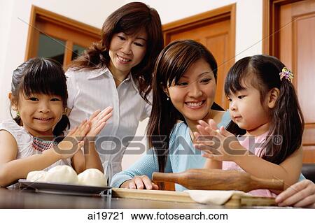 Two girls kneading dough, mother and grandmother looking on View Large Photo Image Stock Image - Two girls kneading dough, mother and grandmother looking on. Fotosearch