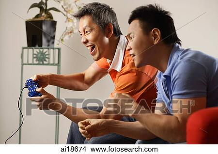 Picture - Two men at home playing with video games. Fotosearch