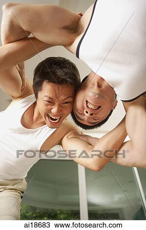Stock Image - Two men wrestling. Fotosearch