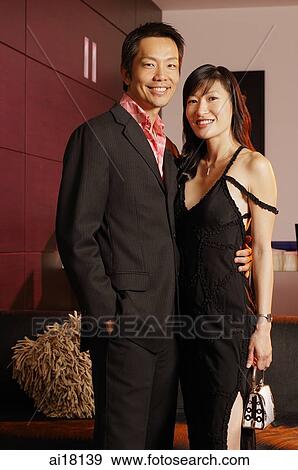 Well dressed couple standing side by side View Large Photo Image Stock Photo - Well dressed couple standing side by side. Fotosearch