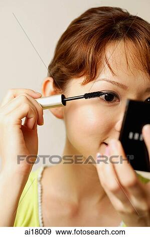 Woman applying mascara View Large Photo Image Stock Photo - Woman applying mascara. Fotosearch