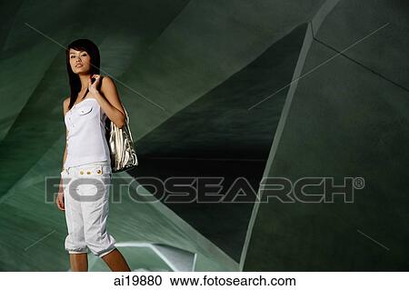 Woman carrying bag over shoulder View Large Photo Image Stock Image - Woman carrying bag over shoulder. Fotosearch