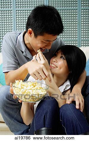 Woman feeding man popcorn View Large Photo Image Stock Photograph - Woman feeding man popcorn. Fotosearch