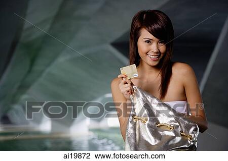 Woman holding gold credit card View Large Photo Image Stock Image - Woman holding gold credit card. Fotosearch