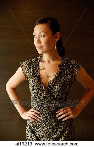 Woman in animal print dress, hands on hips, looking away View Large Photo Image Stock Image - Woman in animal print dress, hands on hips, looking away. Fotosearch