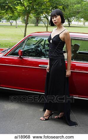 Stock Photo - Woman in black dress looking at camera. Fotosearch