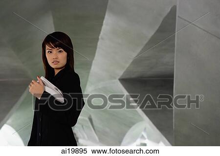 Woman in black jacket, holding newspaper View Large Photo Image Stock Photography - Woman in black jacket, holding newspaper. Fotosearch