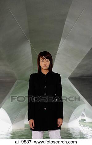 Woman in black jacket standing in tunnel View Large Photo Image Stock Photo - Woman in black jacket standing in tunnel. Fotosearch