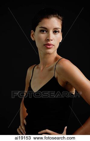 Woman in black tank top, hands on waist, looking at camera View Large Photo Image Stock Image - Woman in black tank top, hands on waist, looking at camera. Fotosearch