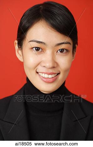 Stock Photography - Woman in black turtleneck, smiling, head shot. Fotosearch