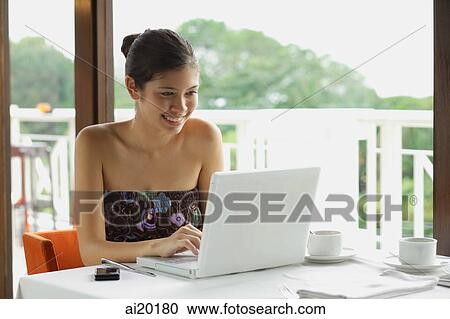 Woman in cafe using laptop View Large Photo Image Stock Image - Woman in cafe using laptop. Fotosearch